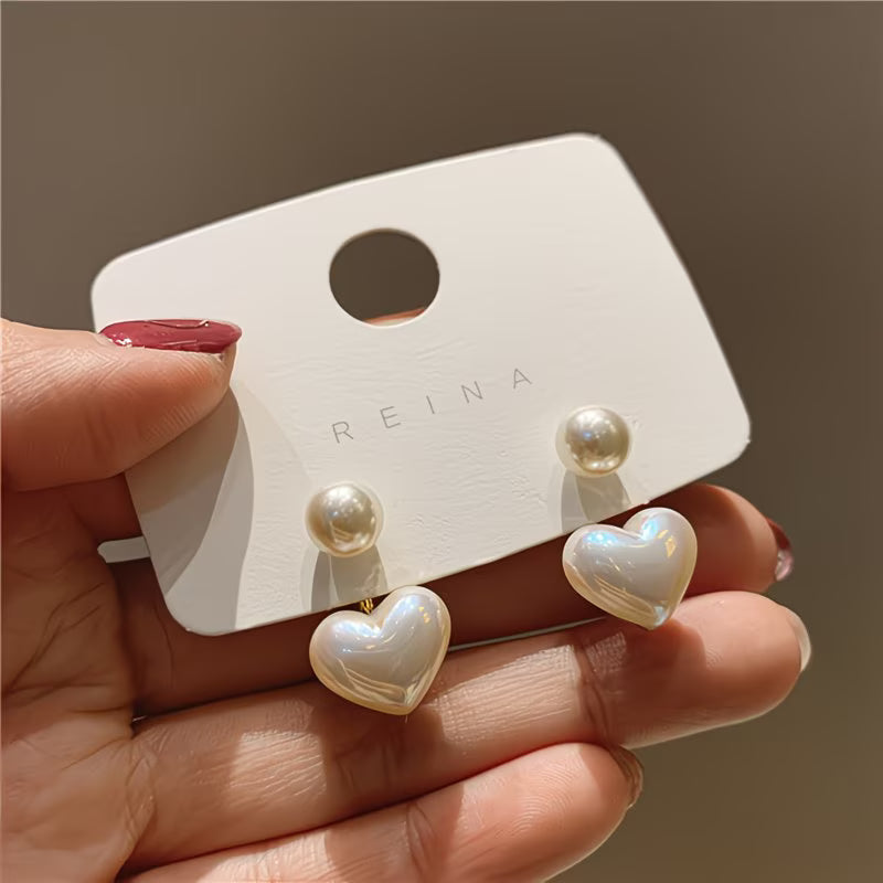 Heart-shaped earrings with double pearl