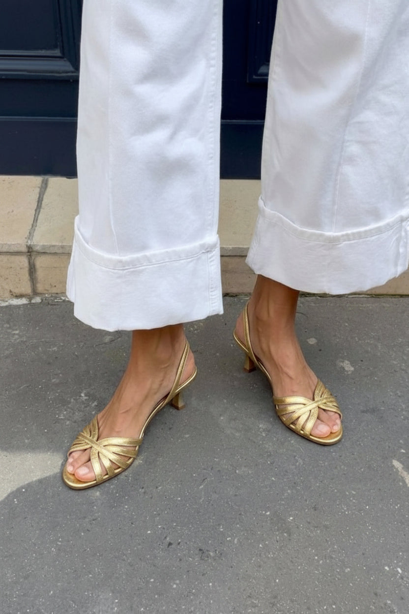 Metallic slingback sandals with crossed straps and a kitten heel