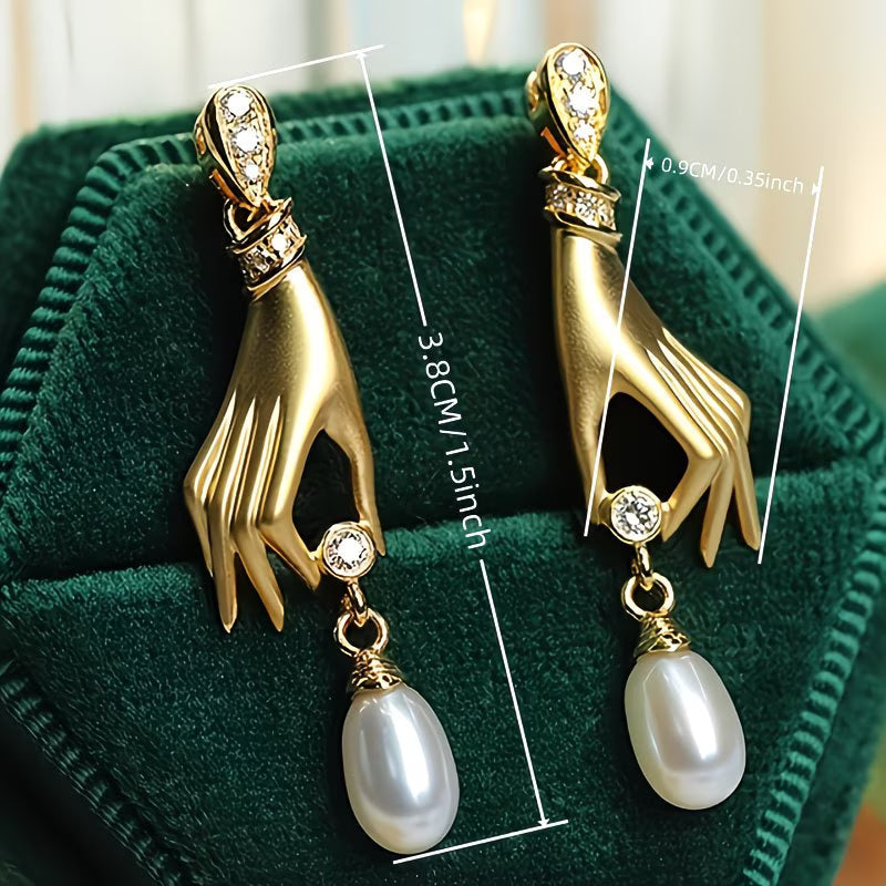 Pearl earrings with elegant hand motif