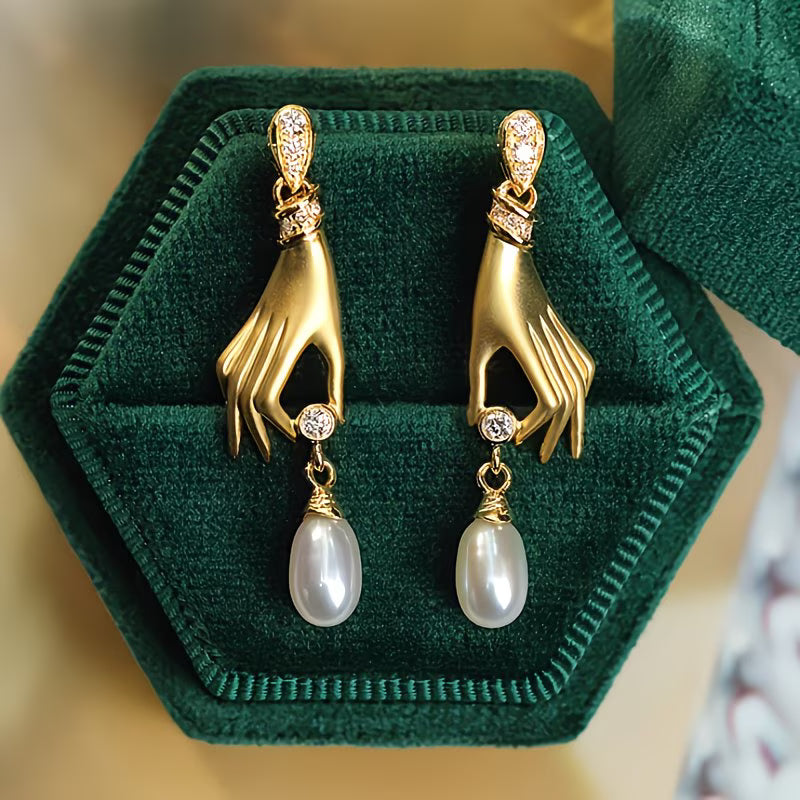 Pearl earrings with elegant hand motif