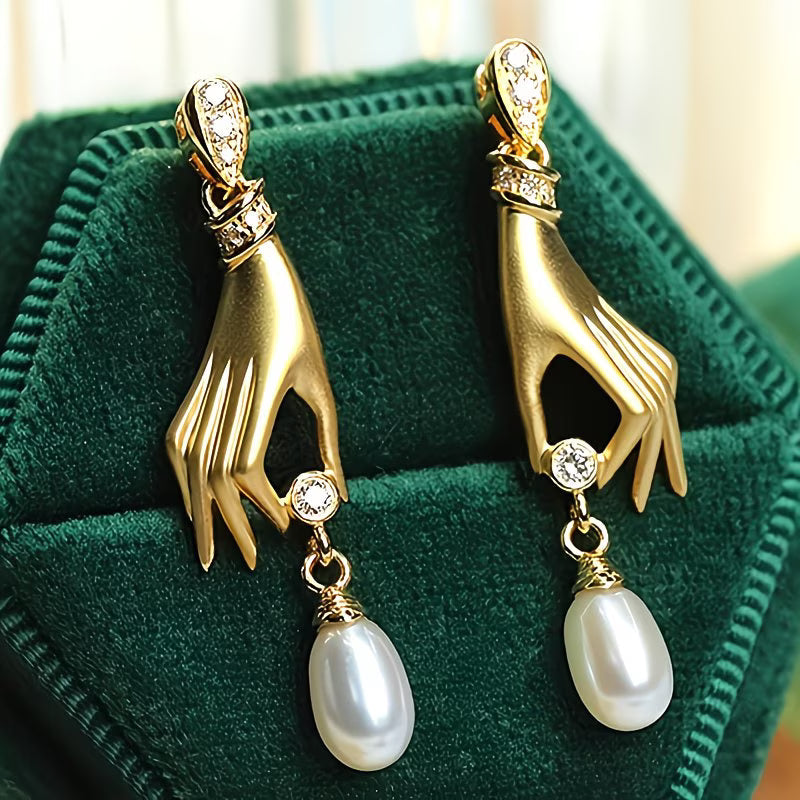 Pearl earrings with elegant hand motif
